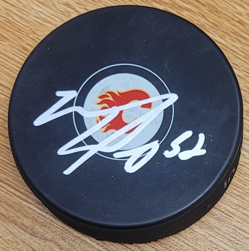 Autographed MACKENZIE WEEGAR Calgary Flames Hockey Puck Main Line