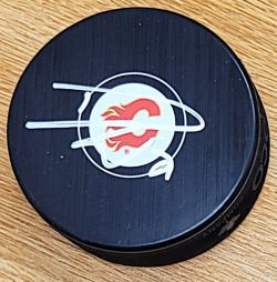 Autographed DUSTIN WOLF Calgary Flames Hockey Puck